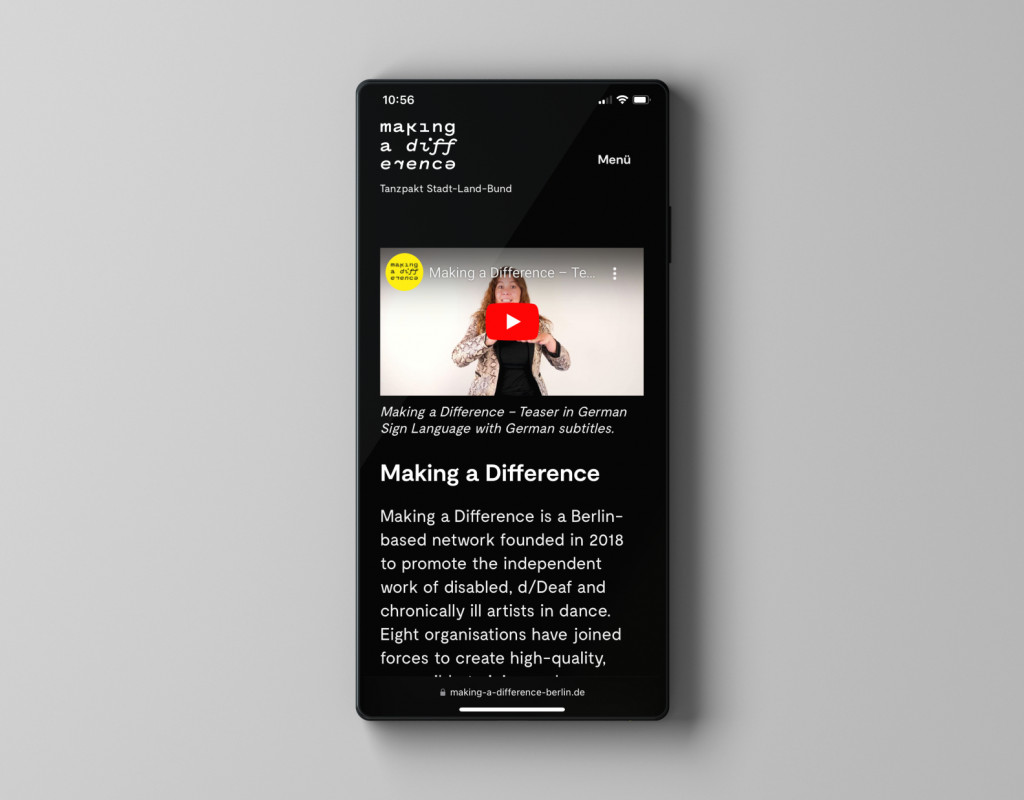 Ein Handy auf dessen Bildschirm die Website im Dark-Mode zu sehen ist.
